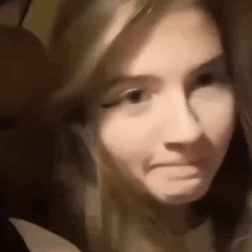 a close up of a woman making a face .