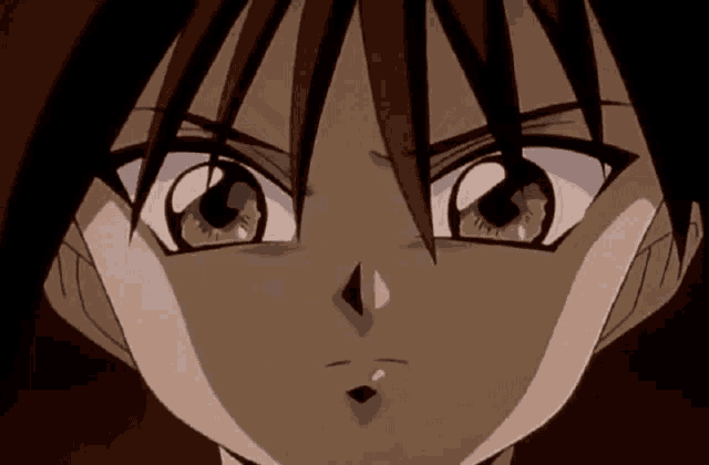a close up of a person 's face with their eyes looking at the camera