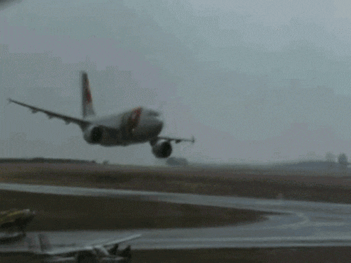 a large passenger jet is taking off from an airport runway