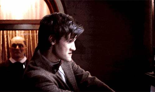 a man in a suit and tie is looking down