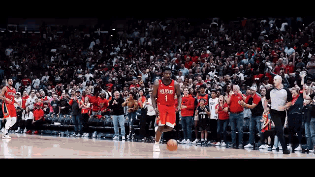 a basketball player wearing a pelicans jersey dribbles the ball