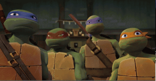 a group of teenage mutant ninja turtles are standing next to each other
