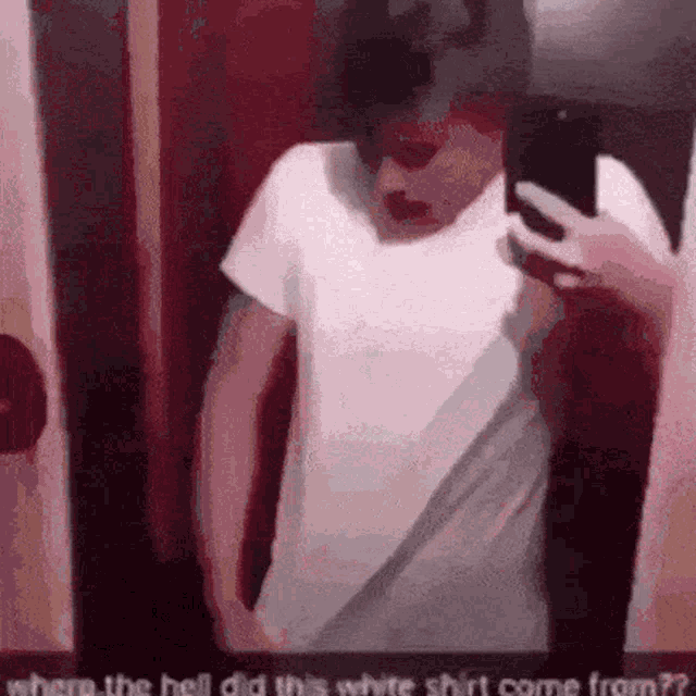 a person is taking a selfie in front of a mirror with the text where the hell did this white shirt come from ?