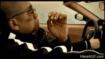 a man smoking a cigarette while driving a car
