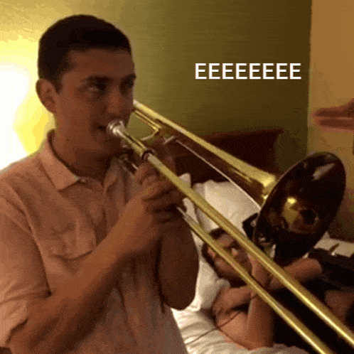 a man playing a trombone with the word eeeeee on the bottom right corner