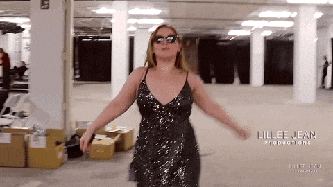a woman in a sequined dress is dancing in an empty room with the name lillee jean productions written on the bottom