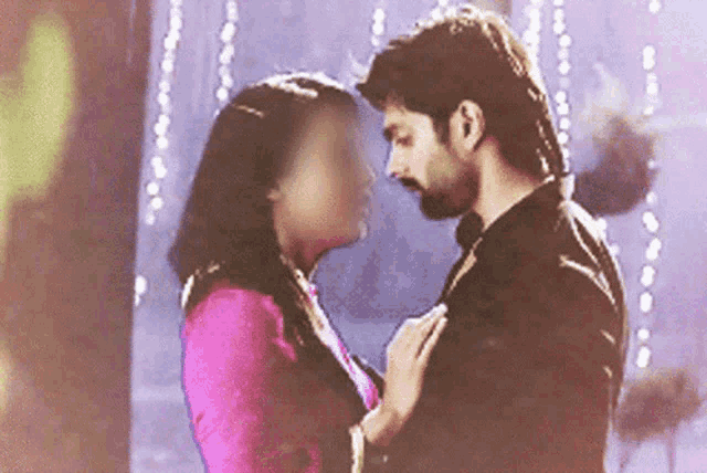 a man and woman are looking into each other 's eyes .