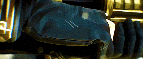 a close up of a person 's arm with a blue glove on