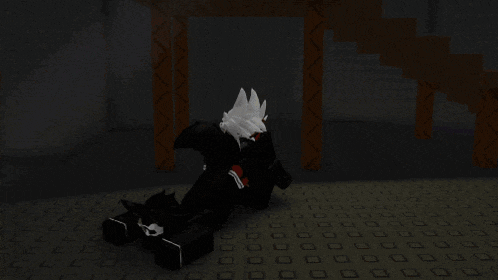 a person in a video game is sitting in a dark room with boxes in the background