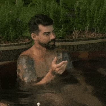 a shirtless man with a tattoo on his arm that reads familia