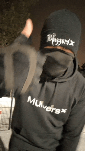 a person wearing a black hoodie that says muwersx on it
