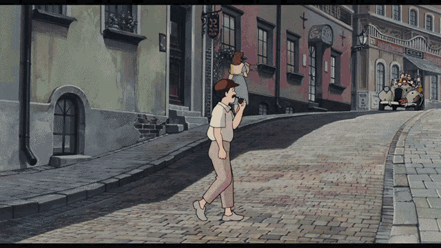 a man carrying a child on his shoulders walks down a cobblestone street in a city