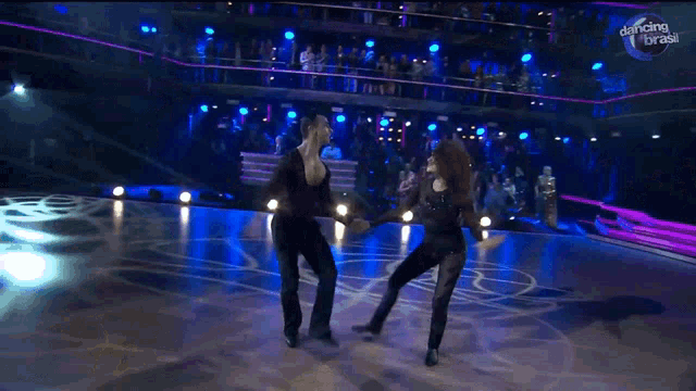 a couple of people are dancing on a dance floor with dancing brasil written on the bottom right