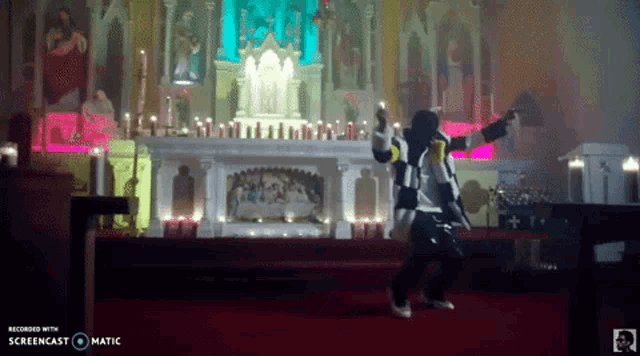 a man is dancing in a church with a screencast watermark