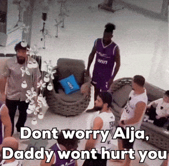 a group of men are standing in a living room with the words " dont worry alja daddy wont hurt you "