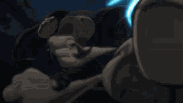 a person is holding a sword with a blue light coming from it .