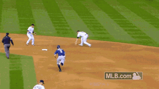a baseball player with the number 5 on his jersey slides into base