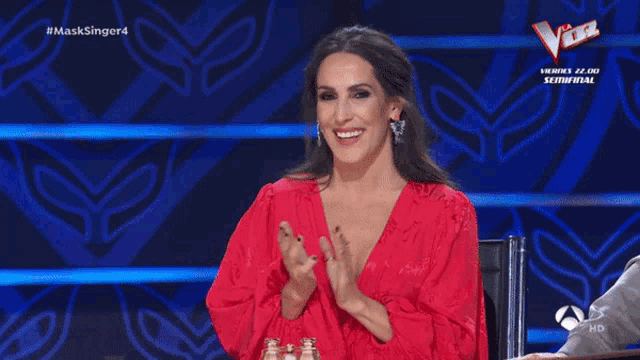 a woman in a red dress has the name malu on her sign