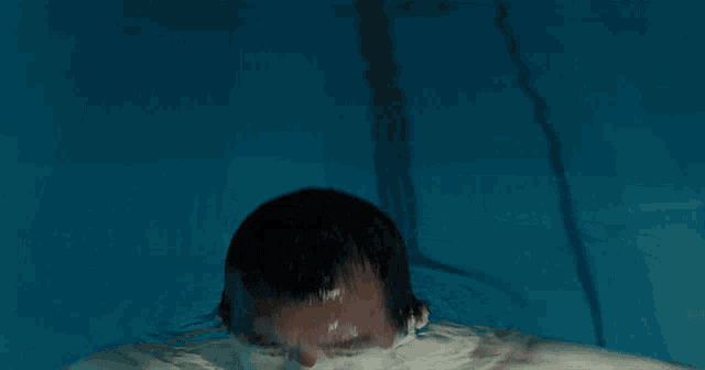 a man with a beard is floating in the water