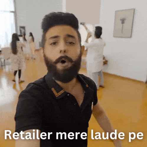a man with a beard says retailer mere laude pe in a room
