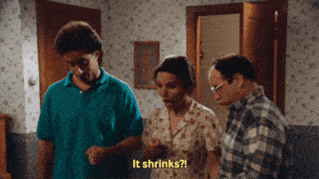 a group of people are standing in a room and one of them is saying " it shrinks "