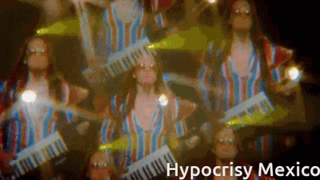 a blurred image of a woman holding a keyboard with hypocrisy mexico written in the corner