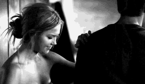 a black and white photo of a man and a woman dancing .