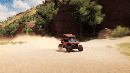 an orange atv is driving down a sandy road