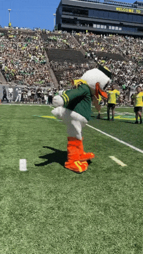 a mascot on a football field with a sign that says welcome to