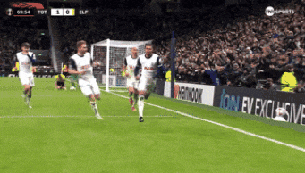 a group of soccer players are running on a field with a hankook advertisement in the background