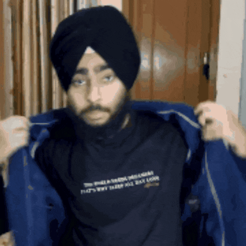 a man wearing a turban and a t-shirt that says " do n't be a fool "