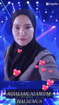 a woman in a hijab is surrounded by pink hearts and says " assalamualaikum hai semua "