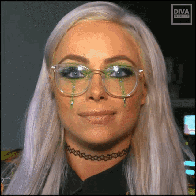 a close up of a woman wearing glasses with green tears coming out of them