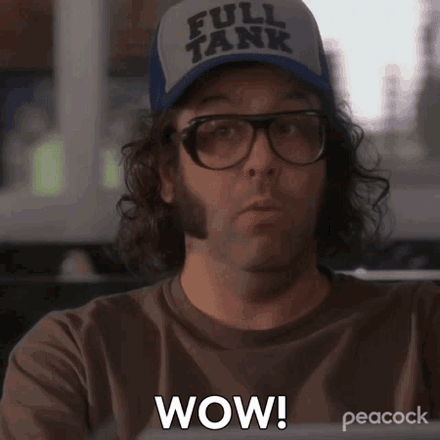 a man wearing glasses and a hat that says full tank