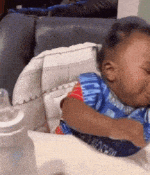 a baby is sitting in a high chair wearing a bib that says moscow