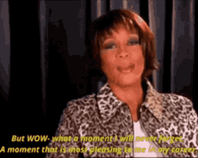a woman in a leopard print jacket is talking about her career