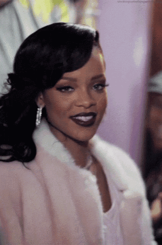 a close up of a woman wearing a fur coat and earrings