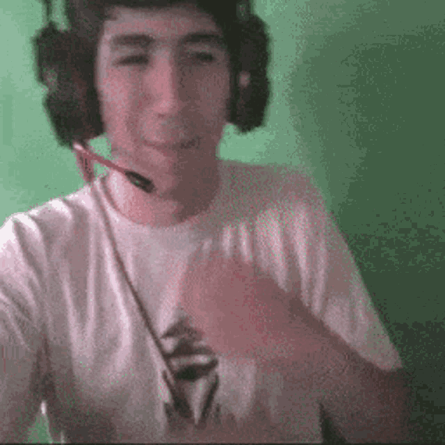 a young man wearing headphones and a microphone is smiling