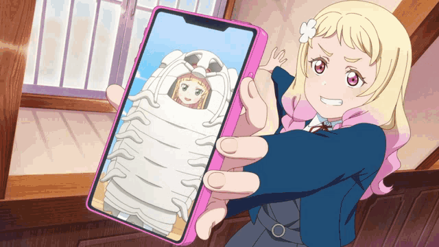 a girl is holding up a cell phone with a picture of a girl on the screen