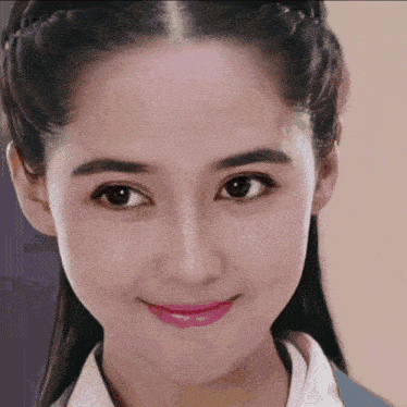 a close up of a woman 's face with a white shirt on