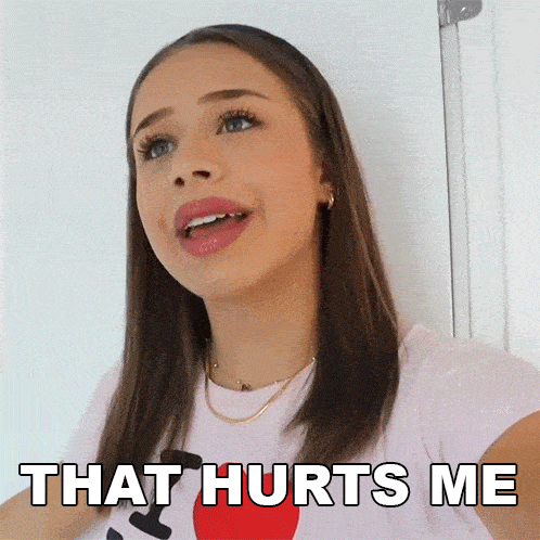a woman says that hurts me in a pink shirt
