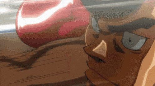 a close up of a person wearing red boxing gloves in a boxing match