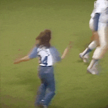 a blurry picture of a baseball player throwing a ball to a girl