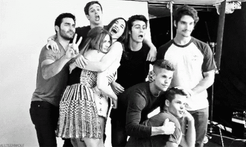 a black and white photo of a group of people posing for a photo .