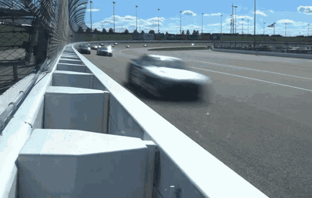 a blurred image of a race car going around a curve
