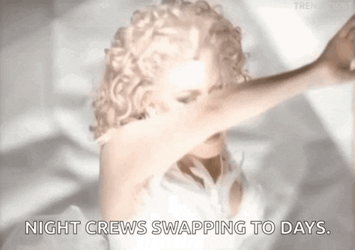 a woman in a white dress is dancing with the words night crews swapping to days written below her .