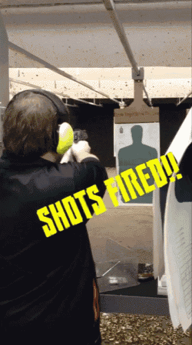 a man wearing a shirt that says shots fired on it