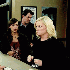 a woman is sitting at a counter with the word no on her hand