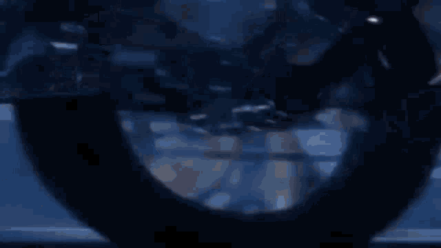 a close up of a motorcycle wheel in a dark room