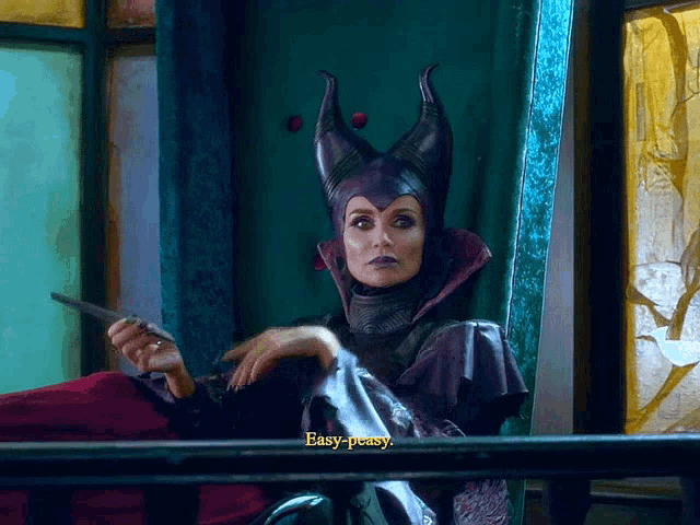 a woman in a maleficent costume says " easy-peasy " while holding a sword